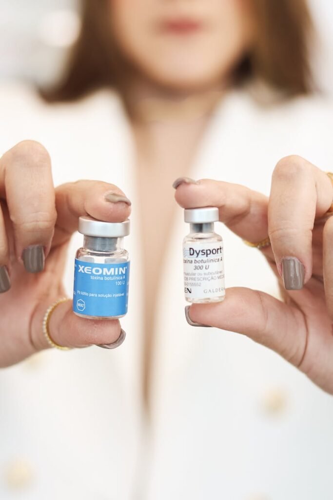 A close-up of a woman holding Xeomin and Dysport vials, showcasing cosmetic treatment options.